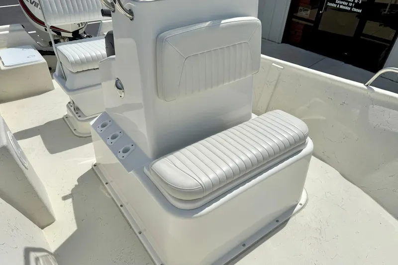 Slide: The Image of 2014 May-Craft 1800 Skiff boat interior with white cushioned seating and console. - 17