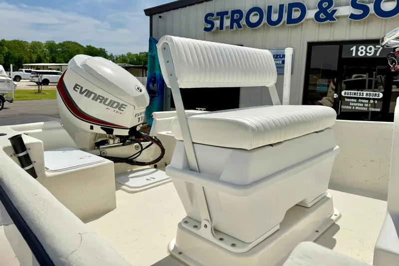 Slide: The Image of 2014 May-Craft 1800 Skiff boat with Evinrude outboard motor, parked outside dealership. - 21