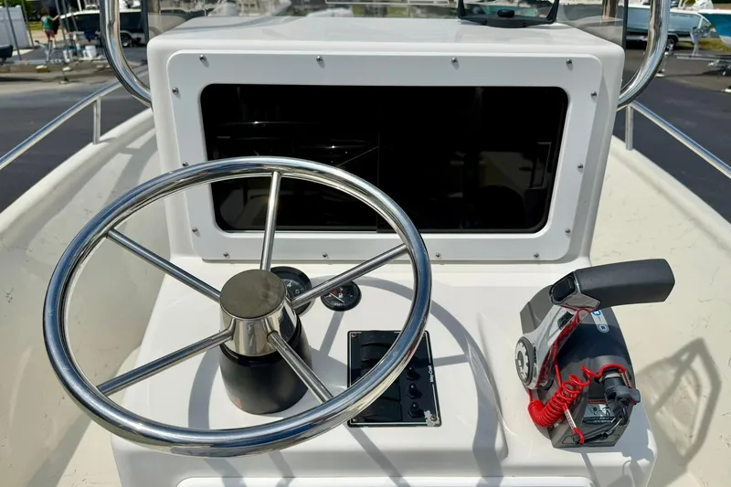 Slide: The Image of Steering console of a 2014 May-Craft 1800 Skiff with throttle control and gauges. - 25