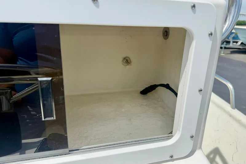 Slide: The Image of Storage compartment on a 2014 May-Craft 1800 Skiff boat, featuring a clean interior. - 26