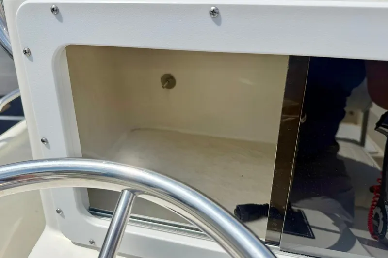 Slide: The Image of 2014 May-Craft 1800 Skiff console detail with steering wheel and storage compartment. - 27