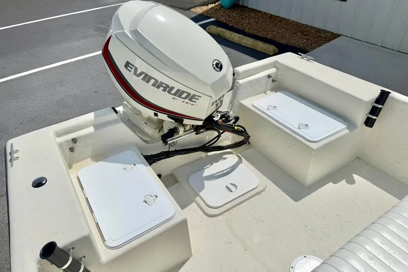 Slide: The Image of 2014 May-Craft 1800 Skiff with Evinrude outboard motor, featuring storage compartments. - 29