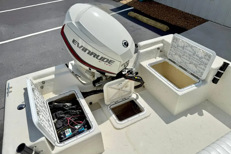 Slide: The Image of 2014 May-Craft 1800 Skiff boat with Evinrude engine and open storage compartments. - 30