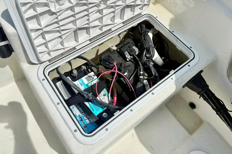 Slide: The Image of Open battery compartment of 2014 May-Craft 1800 Skiff boat, showing marine battery and wiring. - 31