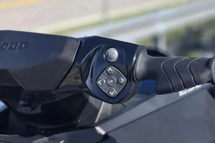 Slide: The Image of Handlebar controls of 2026 Sea-Doo GTX 230, featuring ergonomic grip and navigation buttons. - 14