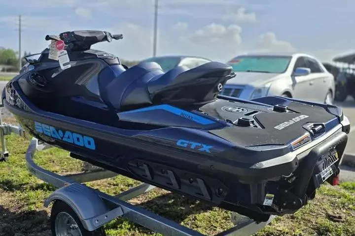 Slide: The Image of 2026 Sea-Doo GTX 230 jet ski on trailer, parked outdoors. - 5