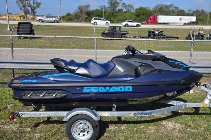 Slide: The Image of 2026 Sea-Doo GTX 230 jet ski on trailer, parked outdoors. - 7