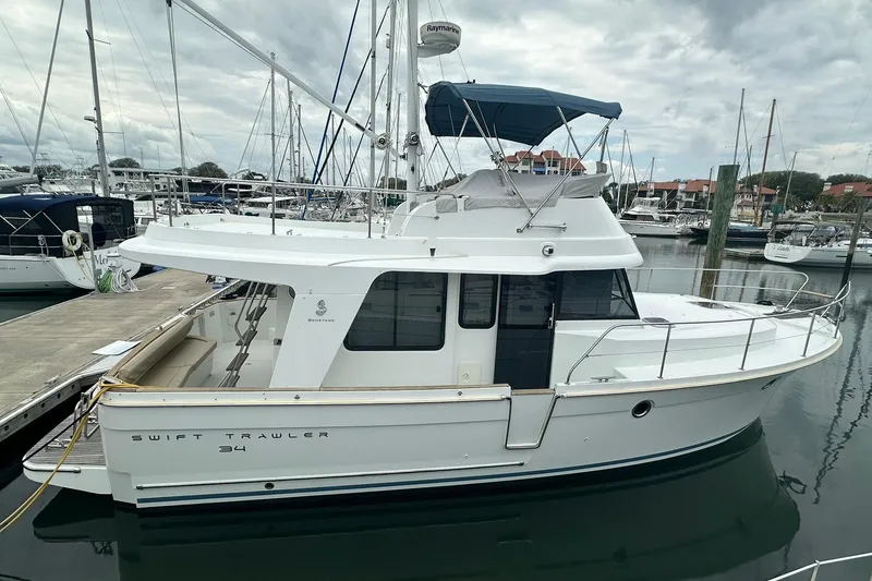 The Image of 2011 Beneteau Swift Trawler 34 Fly moored at a marina, side view. - 0