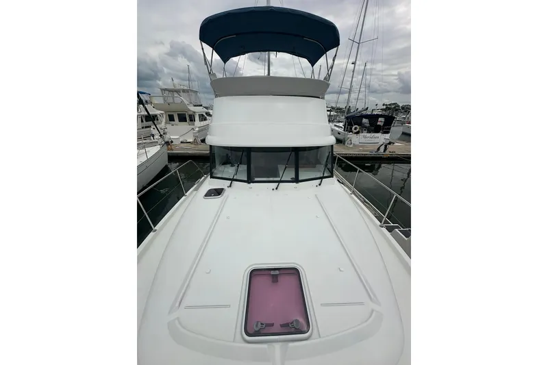 Slide: The Image of 2011 Beneteau Swift Trawler 34 Fly at marina, featuring flybridge and sleek design. - 10