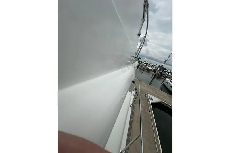 Slide: The Image of 2011 Beneteau Swift Trawler 34 Fly docked at marina, side view. - 15