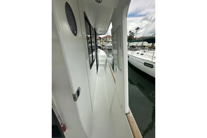 Slide: The Image of Side deck view of a 2011 Beneteau Swift Trawler 34 Fly in a marina. - 17