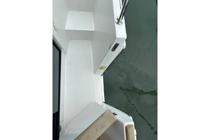 Slide: The Image of 2011 Beneteau Swift Trawler 34 Fly deck view with railing and water reflection. - 18