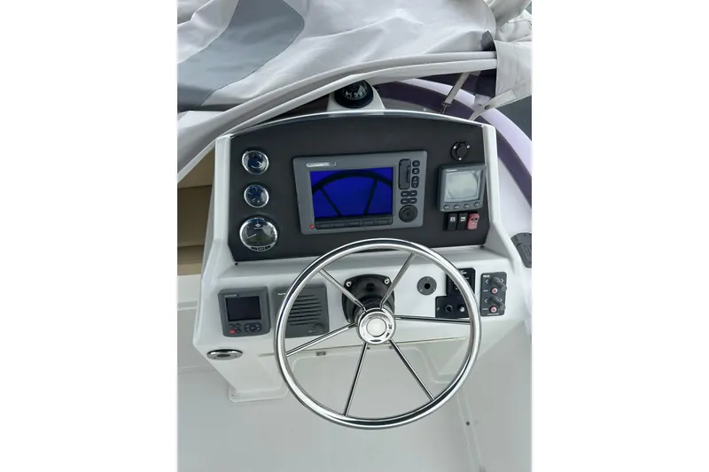 Slide: The Image of Helm of 2011 Beneteau Swift Trawler 34 Fly with navigation instruments and steering wheel. - 20