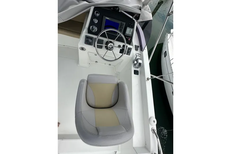 Slide: The Image of Cockpit of 2011 Beneteau Swift Trawler 34 Fly with steering wheel and controls. - 21