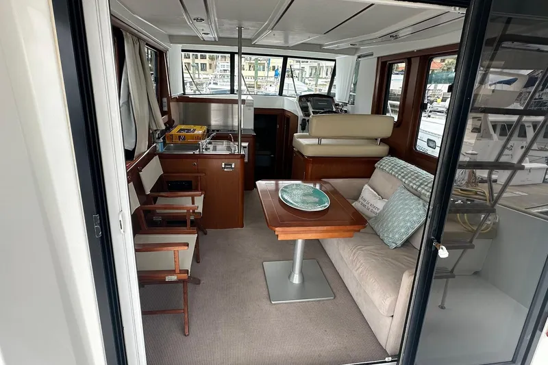 Slide: The Image of Interior of 2011 Beneteau Swift Trawler 34 Fly, featuring cozy seating and dining area. - 34