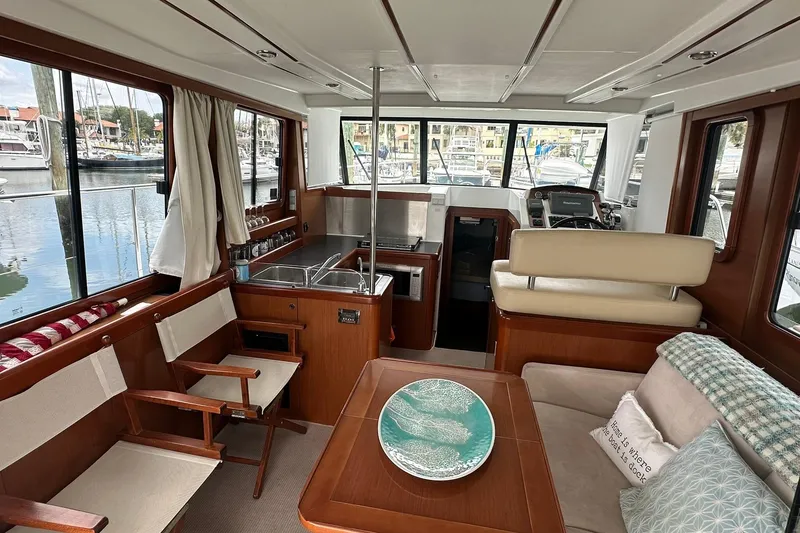 Slide: The Image of Interior of 2011 Beneteau Swift Trawler 34 Fly, featuring cozy seating and kitchenette. - 37