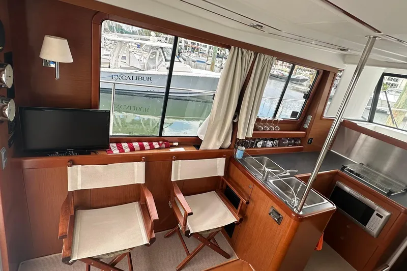 Slide: The Image of Interior of 2011 Beneteau Swift Trawler 34 Fly with kitchen and seating area. - 38