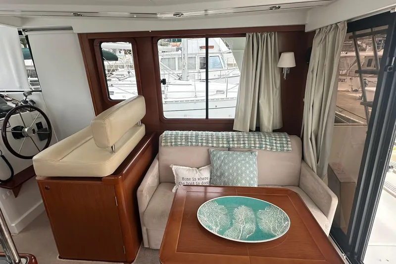 Slide: The Image of Interior of 2011 Beneteau Swift Trawler 34 Fly with cozy seating and nautical decor. - 39