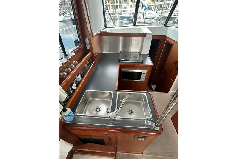 Slide: The Image of 2011 Beneteau Swift Trawler 34 Fly kitchen with sink, stove, and microwave. - 40