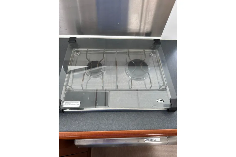 Slide: The Image of Stove with glass cover on 2011 Beneteau Swift Trawler 34 Fly yacht. - 44