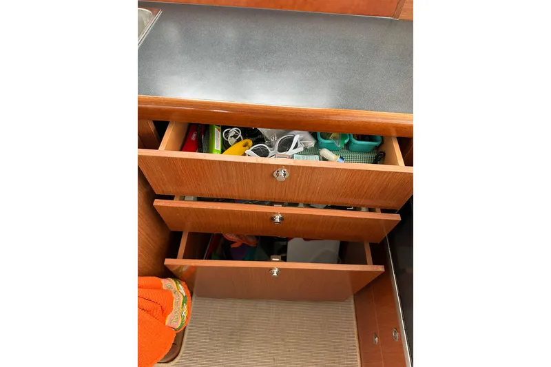 Slide: The Image of Open drawers in a 2011 Beneteau Swift Trawler 34 Fly, revealing stored items. - 46