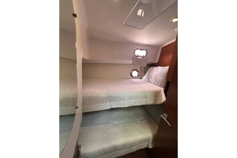 Slide: The Image of Cozy cabin with bunk beds in 2011 Beneteau Swift Trawler 34 Fly. - 50