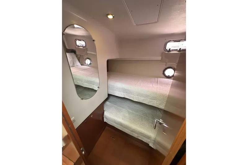 Slide: The Image of Interior cabin of 2011 Beneteau Swift Trawler 34 Fly with bunk beds and porthole. - 51