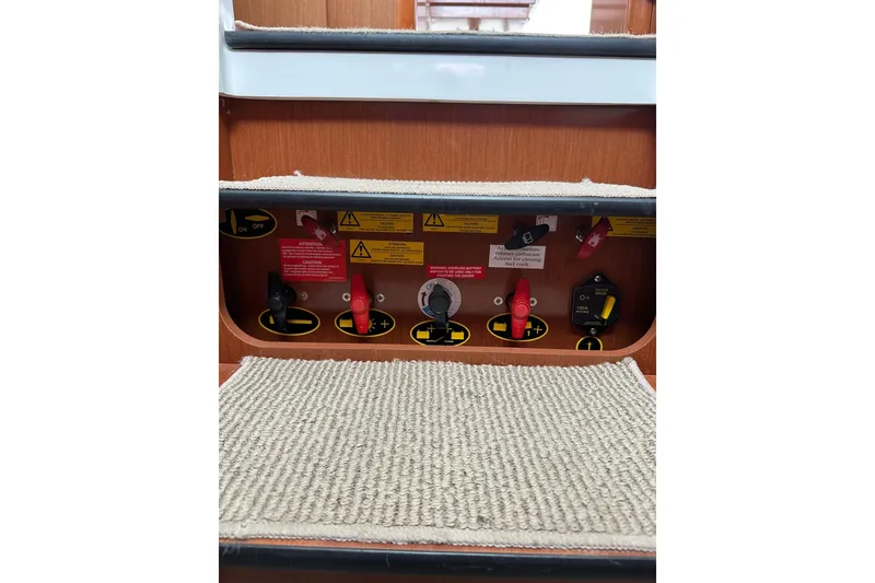 Slide: The Image of Control panel on 2011 Beneteau Swift Trawler 34 Fly, featuring switches and safety labels. - 54