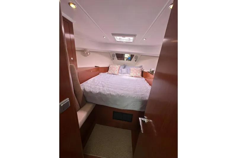 Slide: The Image of Cozy bedroom in 2011 Beneteau Swift Trawler 34 Fly with elegant wood finish. - 56