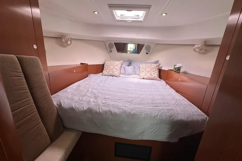 Slide: The Image of Cozy cabin interior of 2011 Beneteau Swift Trawler 34 Fly with bed and cushions. - 57