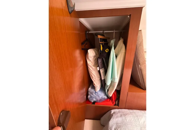 Slide: The Image of Closet inside 2011 Beneteau Swift Trawler 34 Fly with hanging clothes. - 58