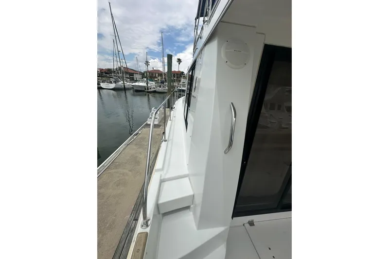 Slide: The Image of 2011 Beneteau Swift Trawler 34 Fly docked at marina, side view. - 6
