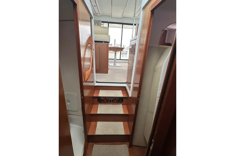 Slide: The Image of Interior view of 2011 Beneteau Swift Trawler 34 Fly, featuring wooden stairs and cozy cabin. - 62