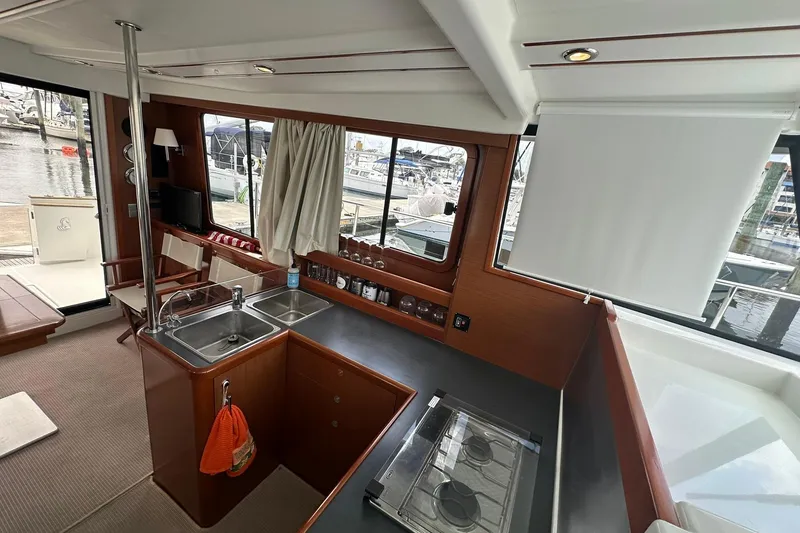 Slide: The Image of Interior of 2011 Beneteau Swift Trawler 34 Fly, featuring kitchen and seating area. - 64
