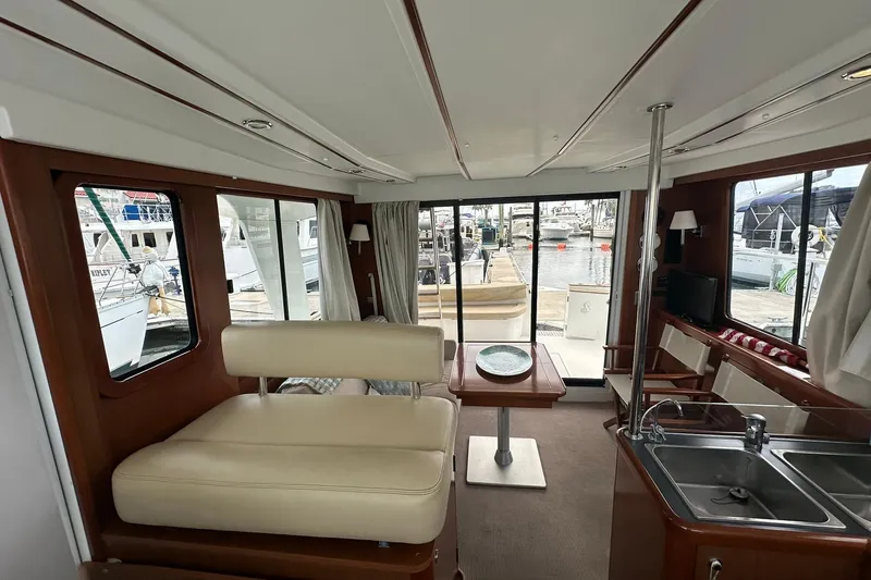 Slide: The Image of Interior of 2011 Beneteau Swift Trawler 34 Fly, featuring seating, table, and kitchenette. - 65