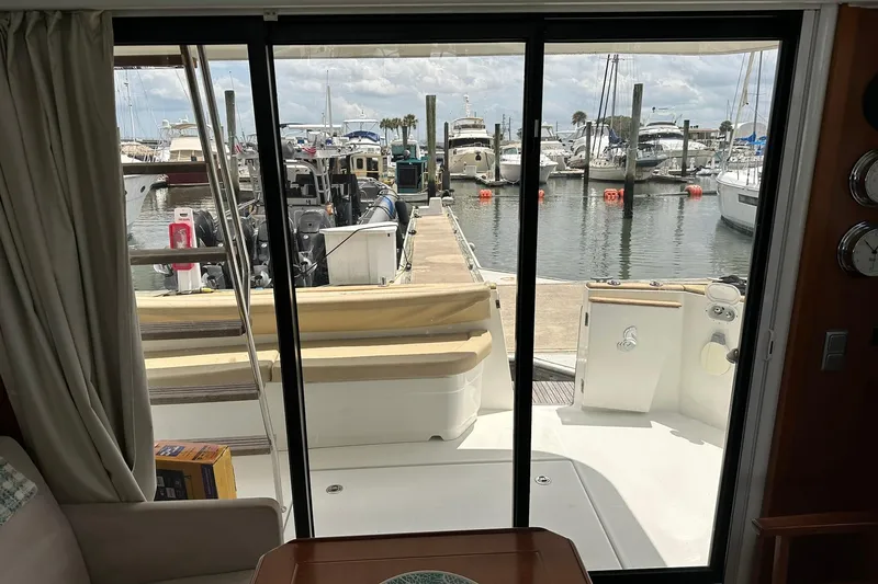 Slide: The Image of Interior view from a 2011 Beneteau Swift Trawler 34 Fly, overlooking a marina. - 66