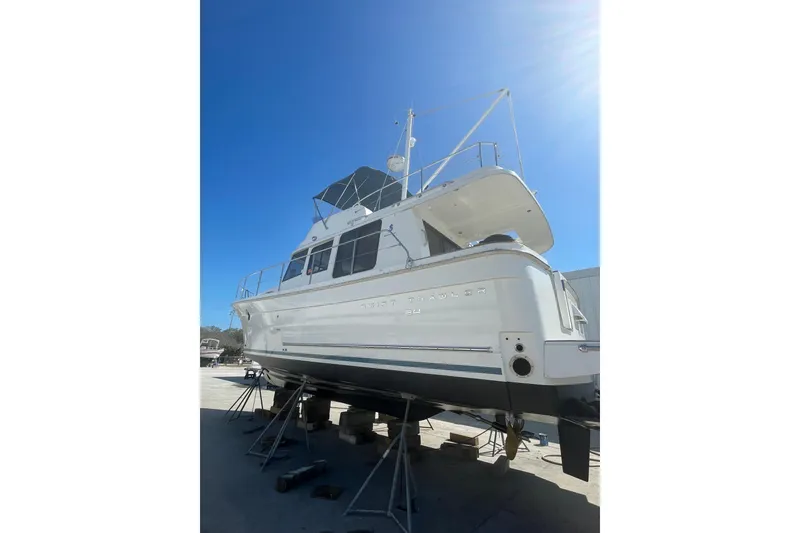 Slide: The Image of 2011 Beneteau Swift Trawler 34 Fly on stands, viewed from rear under clear blue sky. - 71