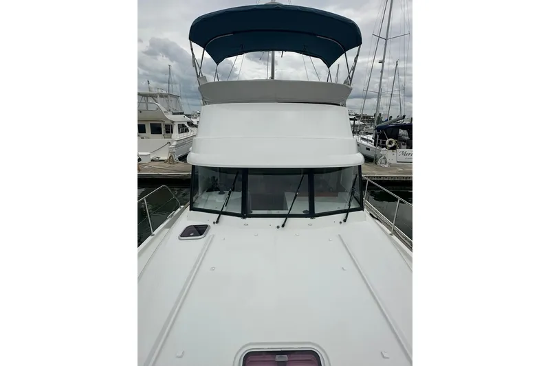 Slide: The Image of 2011 Beneteau Swift Trawler 34 Fly at marina, featuring flybridge and sleek design. - 9