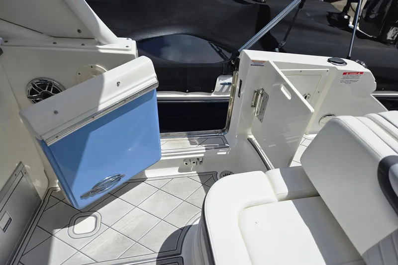 Slide: The Image of 2022 Chaparral 280 OSX boat interior with open storage compartments and seating. - 19