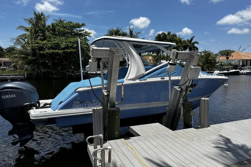Slide: The Image of 2022 Chaparral 280 OSX boat docked, featuring Yamaha outboard motor, surrounded by tropical scenery. - 5
