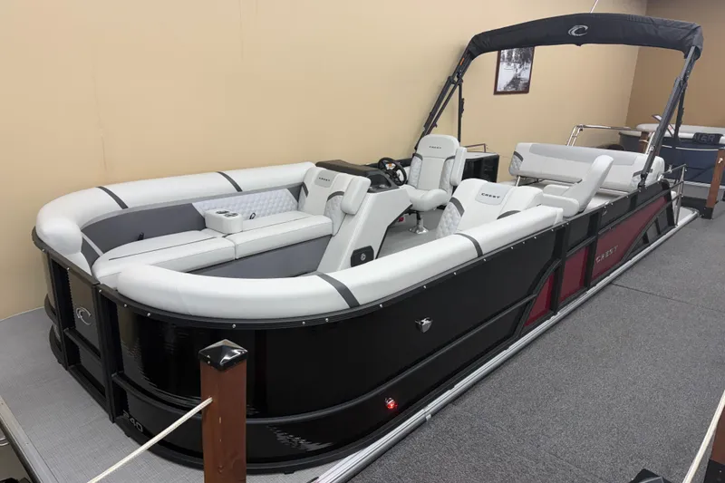 The Image of 2025 Crest Classic 240 pontoon boat with sleek black and red design, luxurious seating. - 0