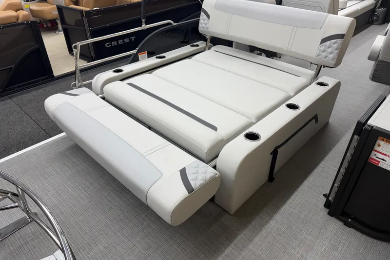 Slide: The Image of 2025 Crest Classic 240 boat interior with luxurious white seating and cup holders. - 11