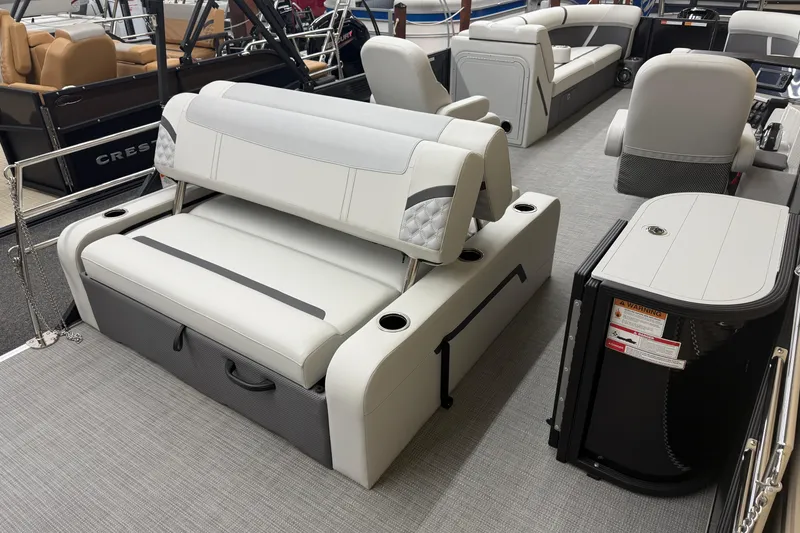 Slide: The Image of 2025 Crest Classic 240 boat interior with luxurious seating and modern design. - 12