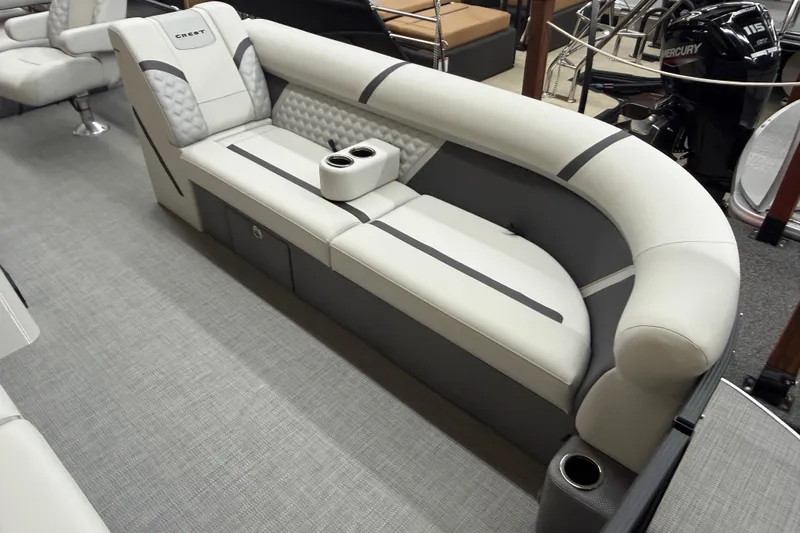 Slide: The Image of 2025 Crest Classic 240 boat interior with plush seating and cup holders. - 3
