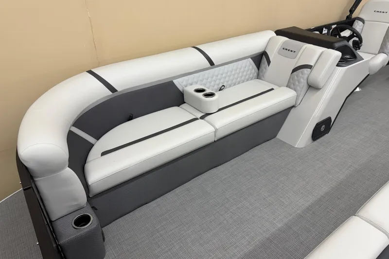 Slide: The Image of 2025 Crest Classic 240 boat interior with gray seating and cup holders. - 4