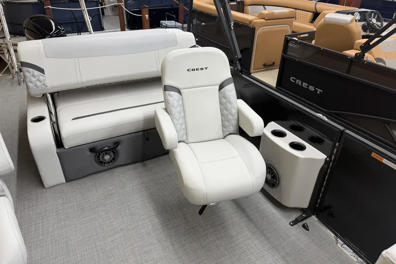 Slide: The Image of 2025 Crest Classic 240 boat interior with white seating and cup holders. - 8