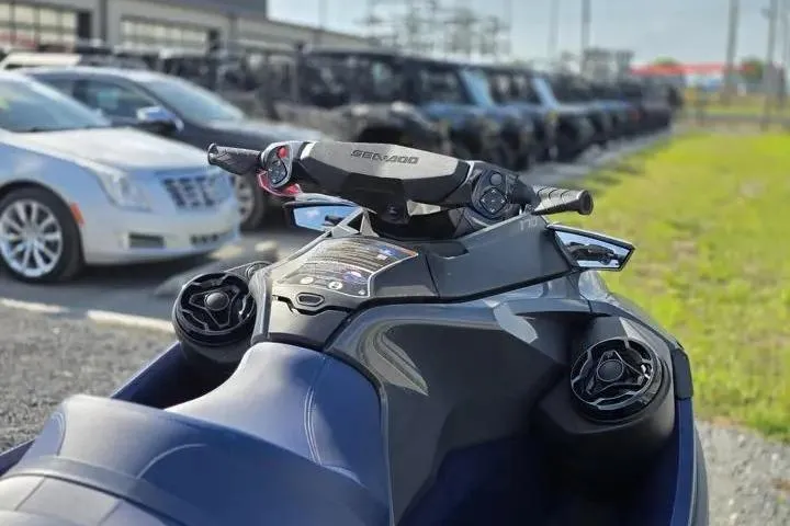 Slide: The Image of 2026 Sea-Doo GTX 170 jet ski parked near cars in a lot. - 10