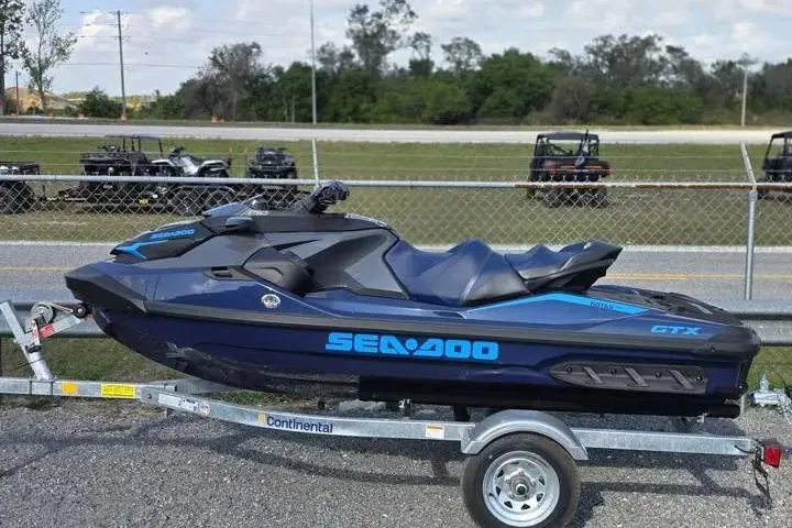 Slide: The Image of 2026 Sea-Doo GTX 170 jet ski on trailer, parked outdoors. - 3