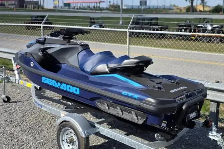 Slide: The Image of 2026 Sea-Doo GTX 170 jet ski on trailer, parked outdoors. - 4