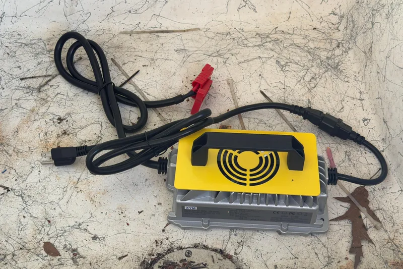 Slide: The Image of Battery charger with cables on a textured surface, suitable for Sea Chaser 2100 CC boat. - 14